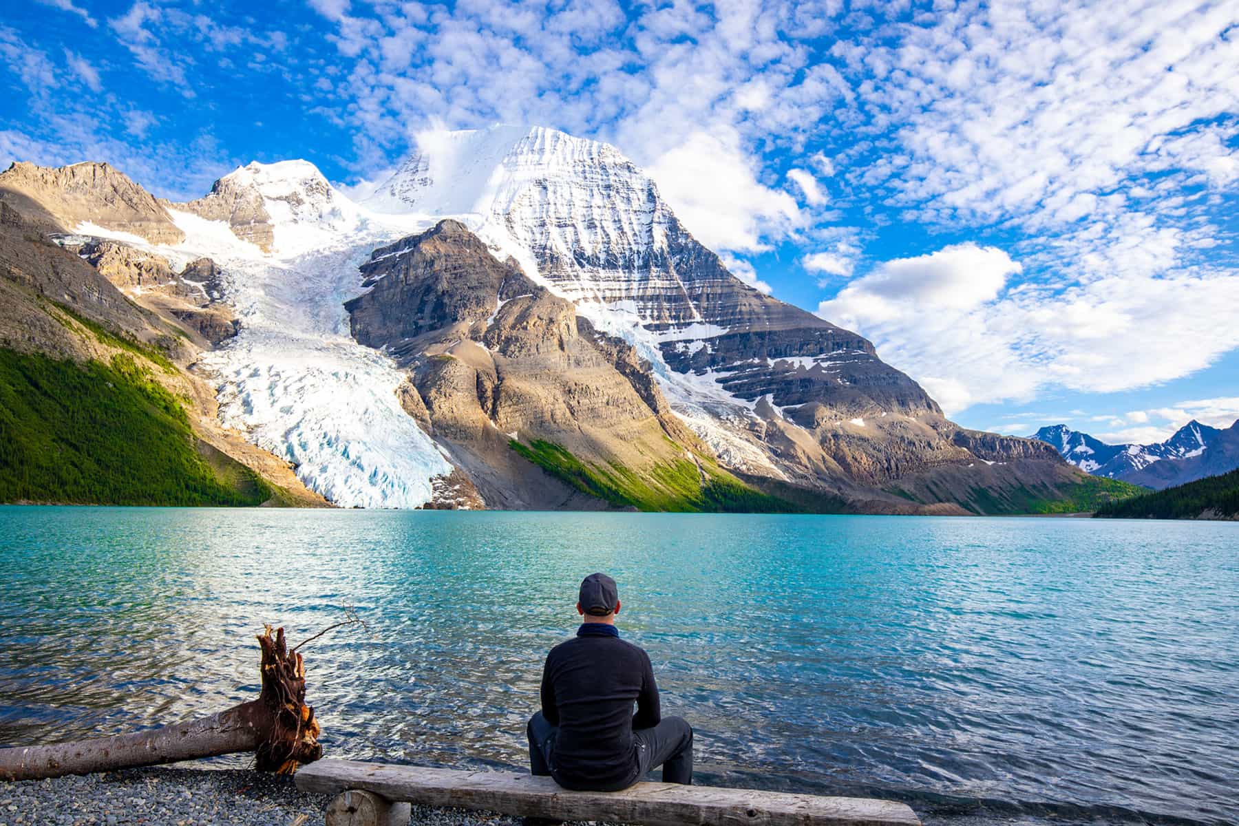 Man contemplating lake and mountains
