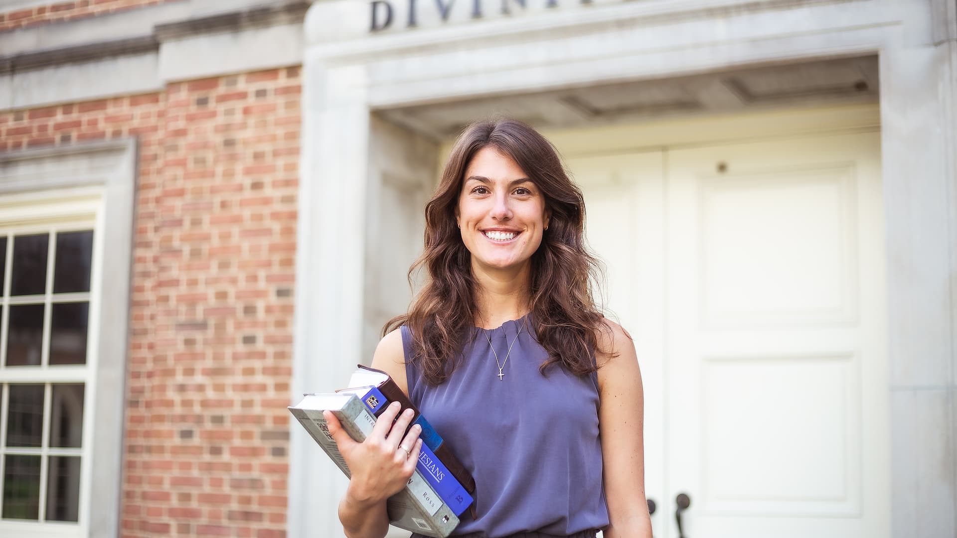 smiling woman holding books